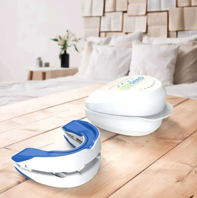 Adjustable Anti-Snoring Device on a wooden table in a cozy bedroom setting.